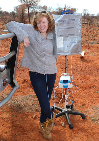 Woman in outback with medical equipment